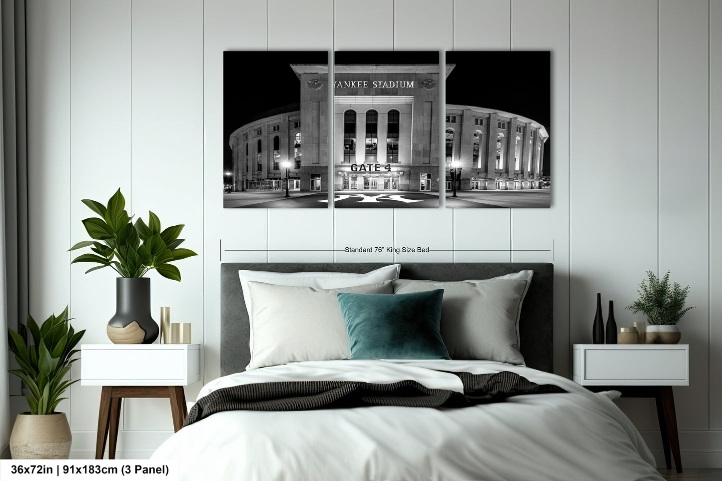 A bedroom with a large black and white photograph of Yankee Stadium hanging on the wall above a bed.