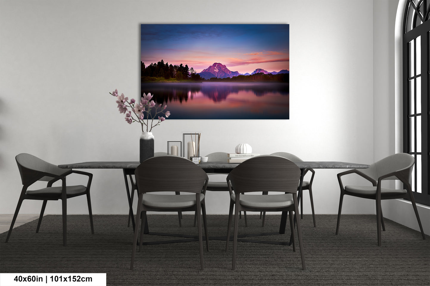 a dining room table with chairs and a painting on the wall