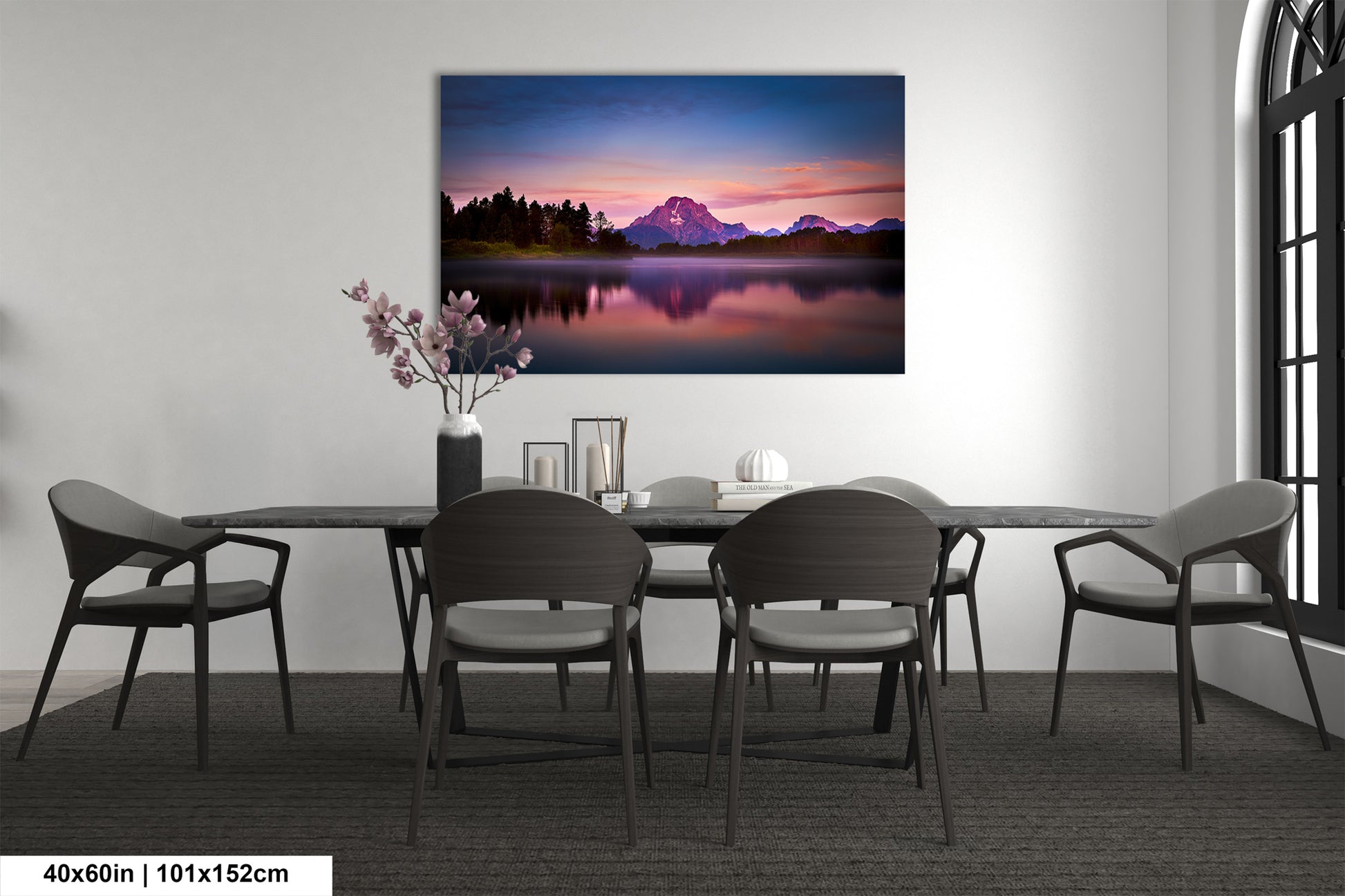a dining room table with chairs and a painting on the wall