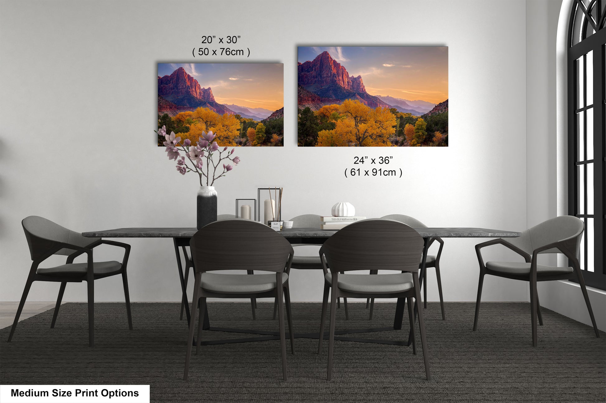 a dining table with four chairs and a vase with flowers