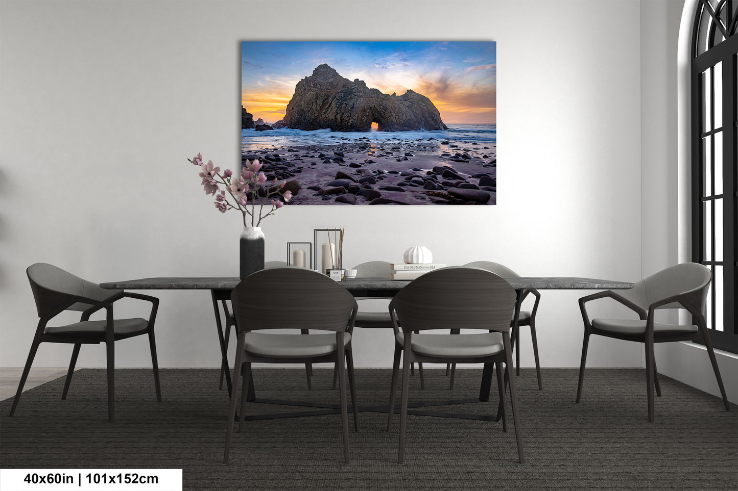 a dining room table with chairs and a painting on the wall