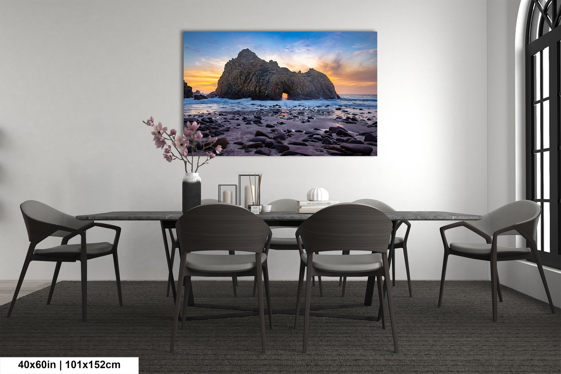 a dining room table with chairs and a painting on the wall