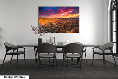 a dining room table with chairs and a painting on the wall