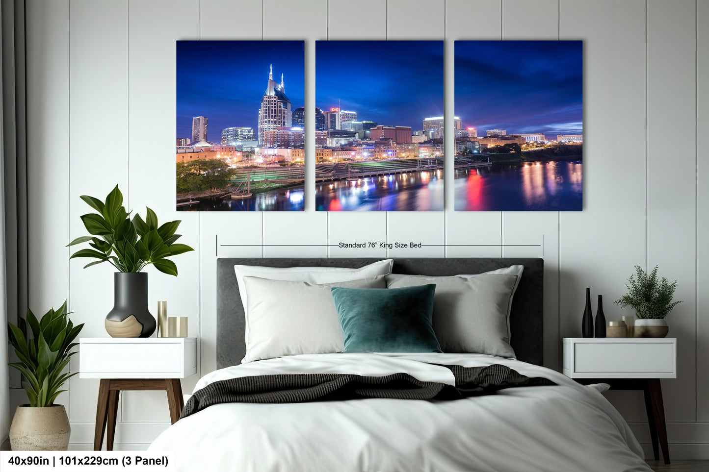 a bedroom with a bed and a night view of a city