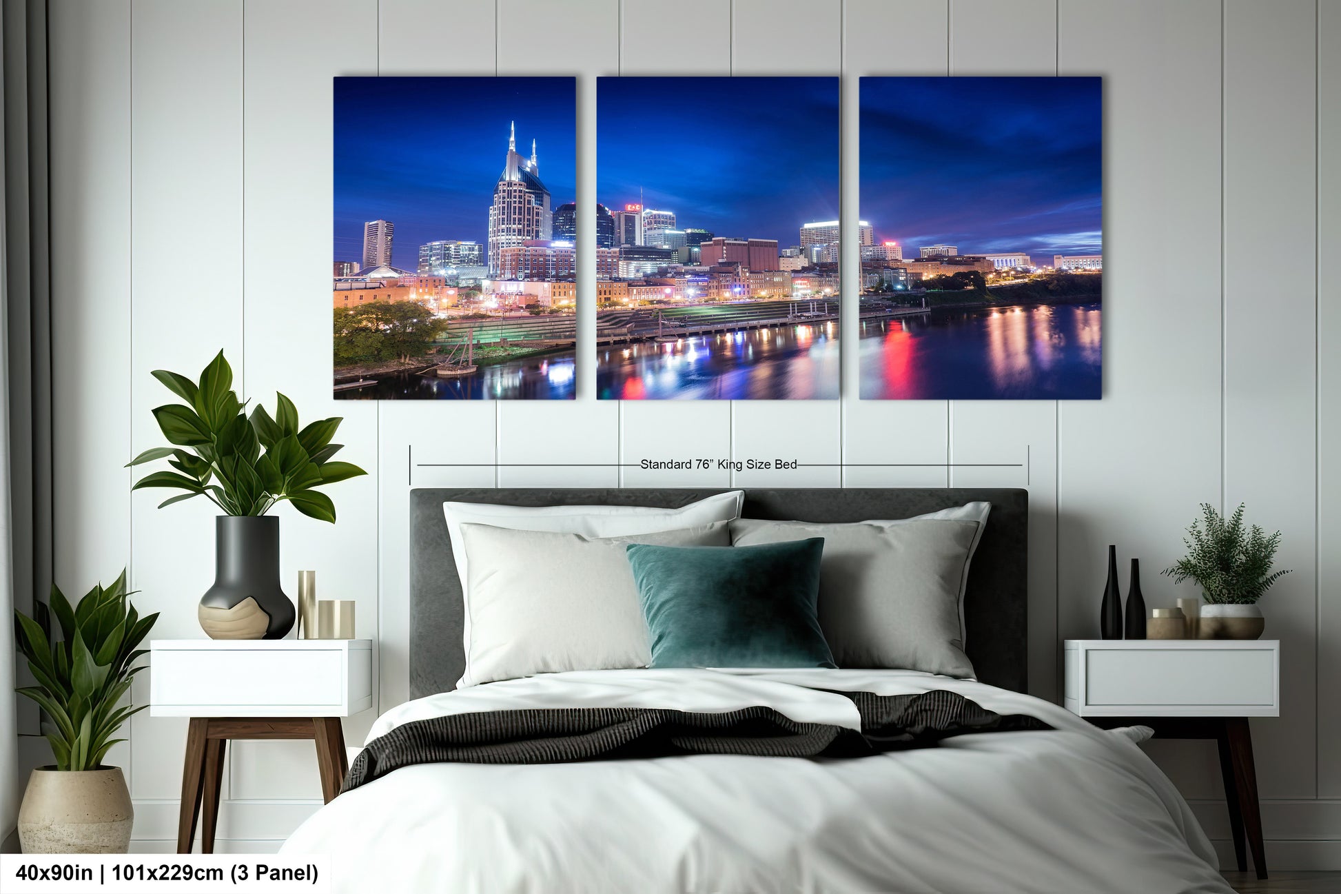 a bedroom with a bed and a night view of a city