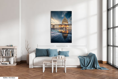 a living room with a white couch and a painting on the wall