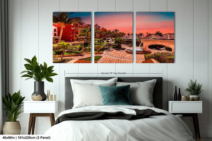 a bedroom with a bed and two paintings on the wall