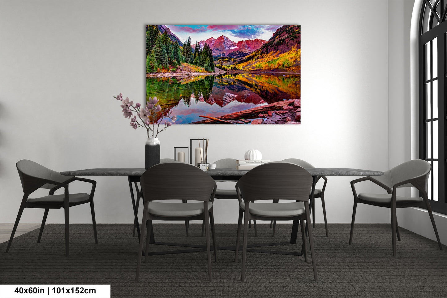 a dining room table with chairs and a painting on the wall