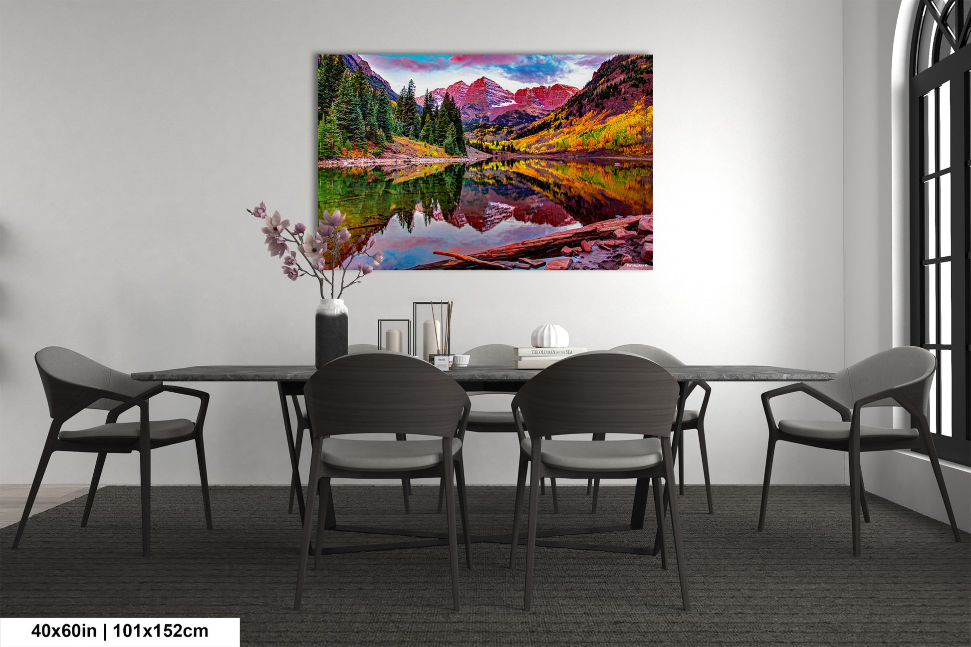 a dining room table with chairs and a painting on the wall