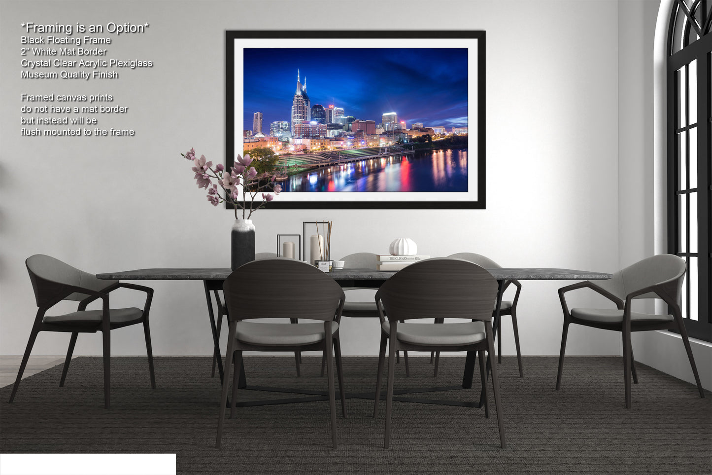 a dining room table with chairs and a picture hanging on the wall