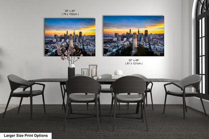 a dining table with four chairs and a vase of flowers