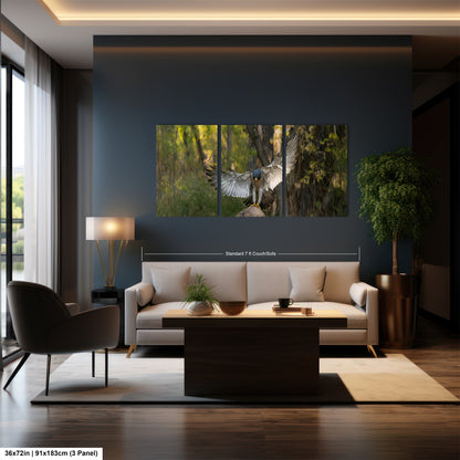 A modern living room with a large wall art depicting a bird in flight. The room has a gray sofa, a wooden coffee table, and a large window overlooking a natural outdoor scene.