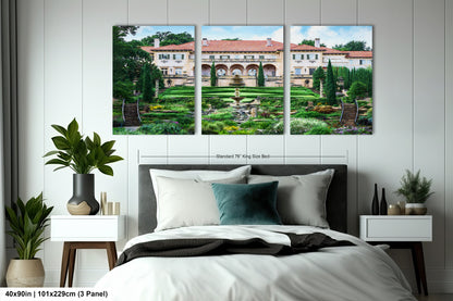 a bed room with a neatly made bed and two paintings on the wall