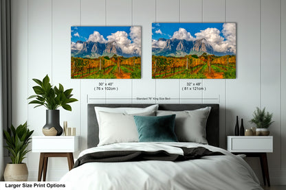 a bedroom with a bed and two pictures on the wall