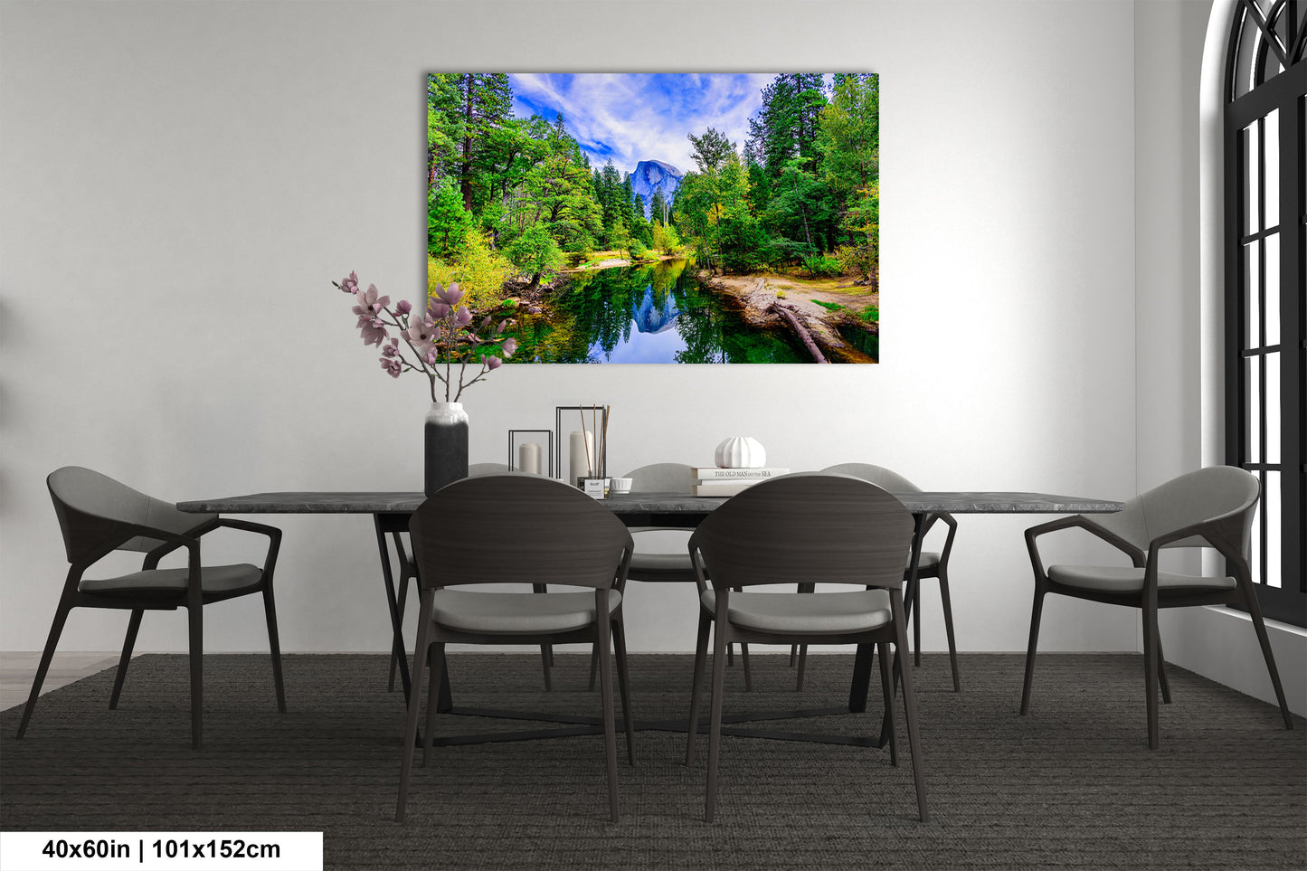 a dining room table with chairs and a painting on the wall