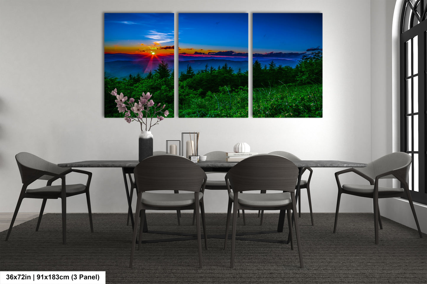 a dining room table with four chairs and a painting on the wall