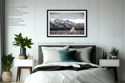 a bedroom with a bed and a picture on the wall