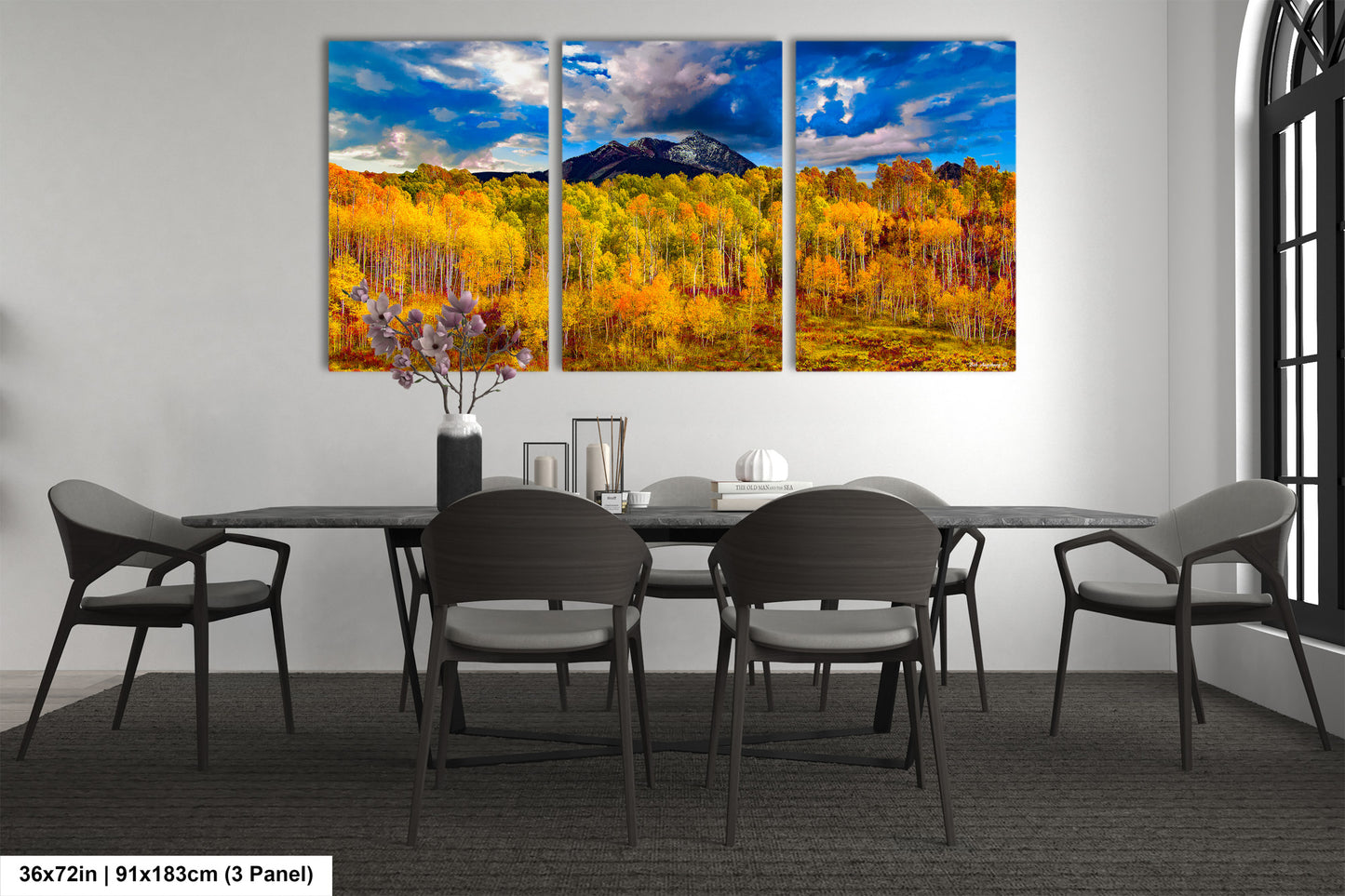 a dining room table with chairs and a painting on the wall