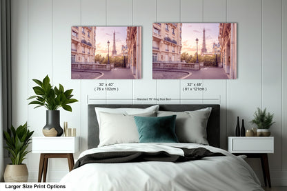 a bedroom with a bed and two pictures on the wall