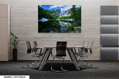 a painting of a mountain lake in the middle of a room