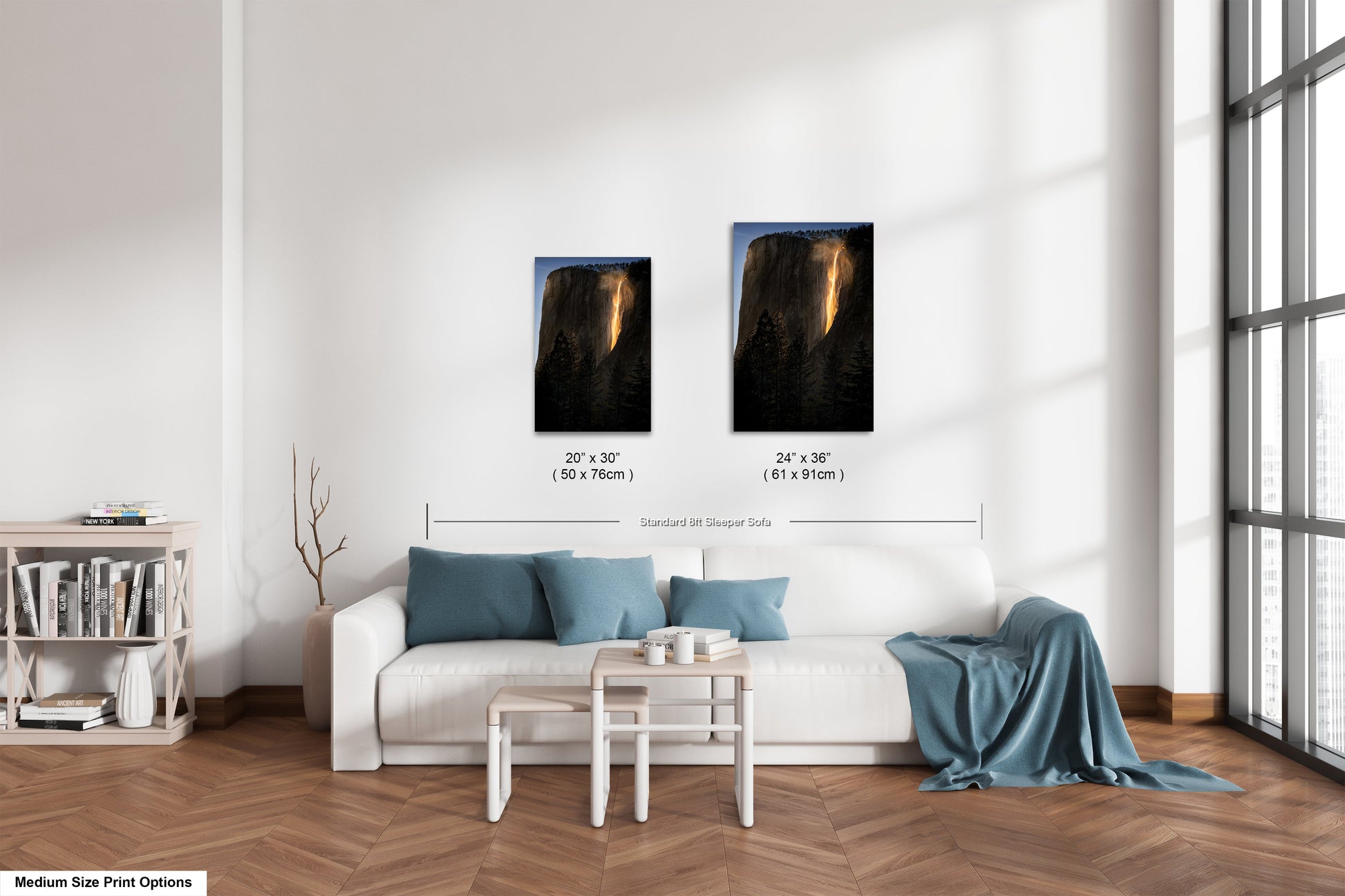 a living room with a white couch and two pictures on the wall