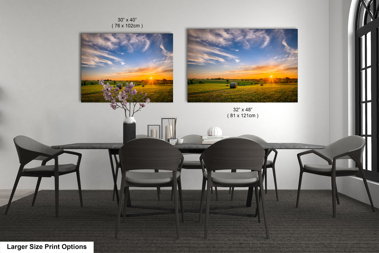 a dining room table with four chairs and a vase of flowers