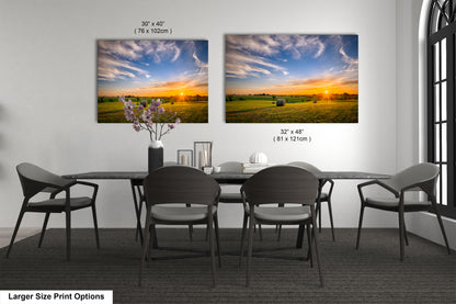 a dining room table with four chairs and a vase of flowers