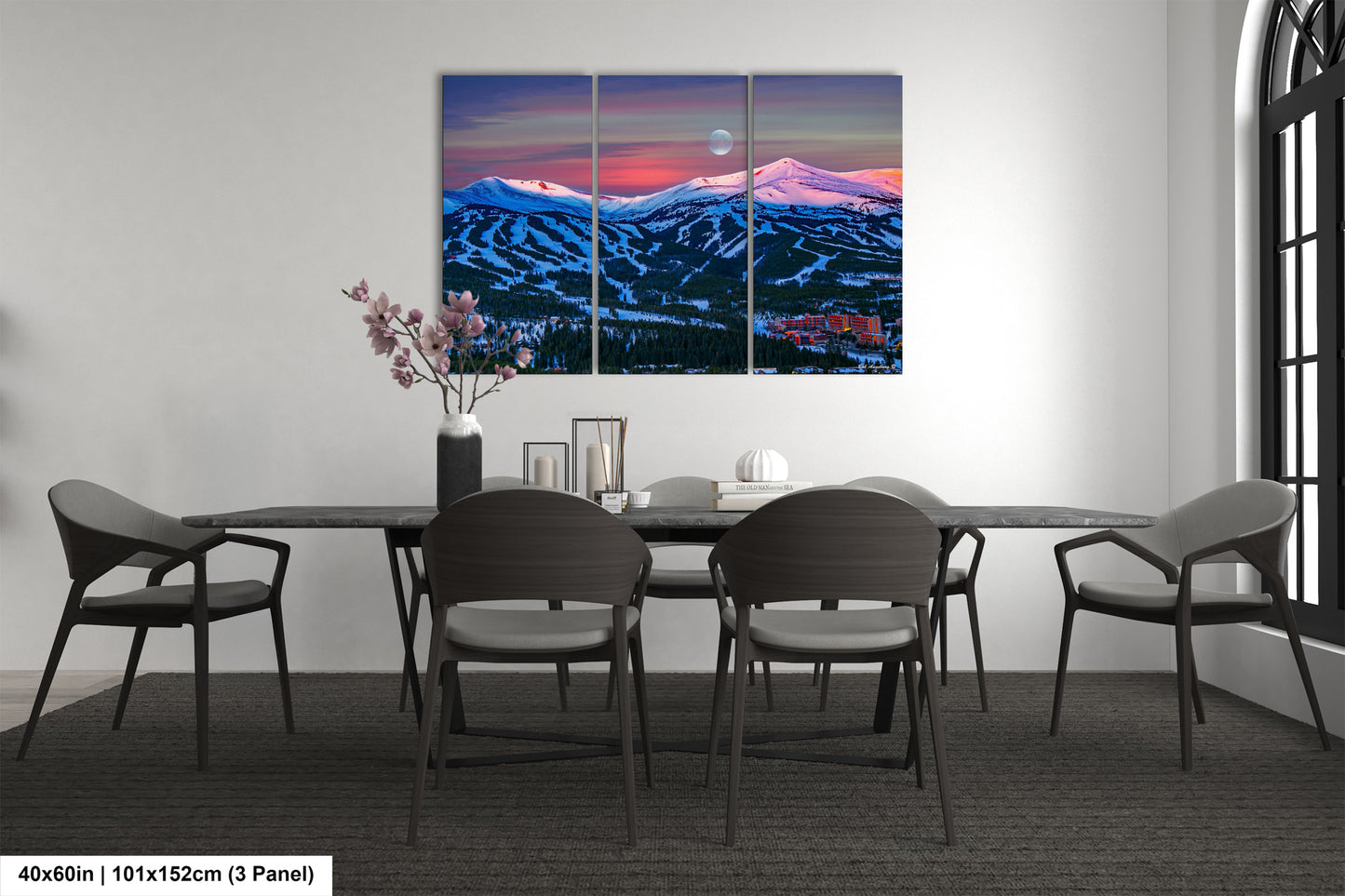 a dining room table with four chairs and a painting on the wall