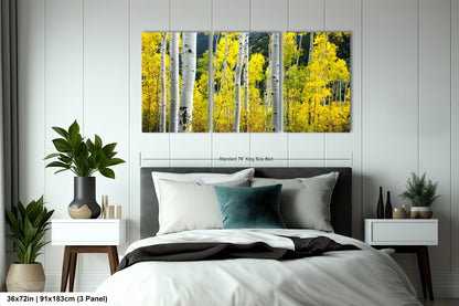 a bed room with a neatly made bed and a painting on the wall