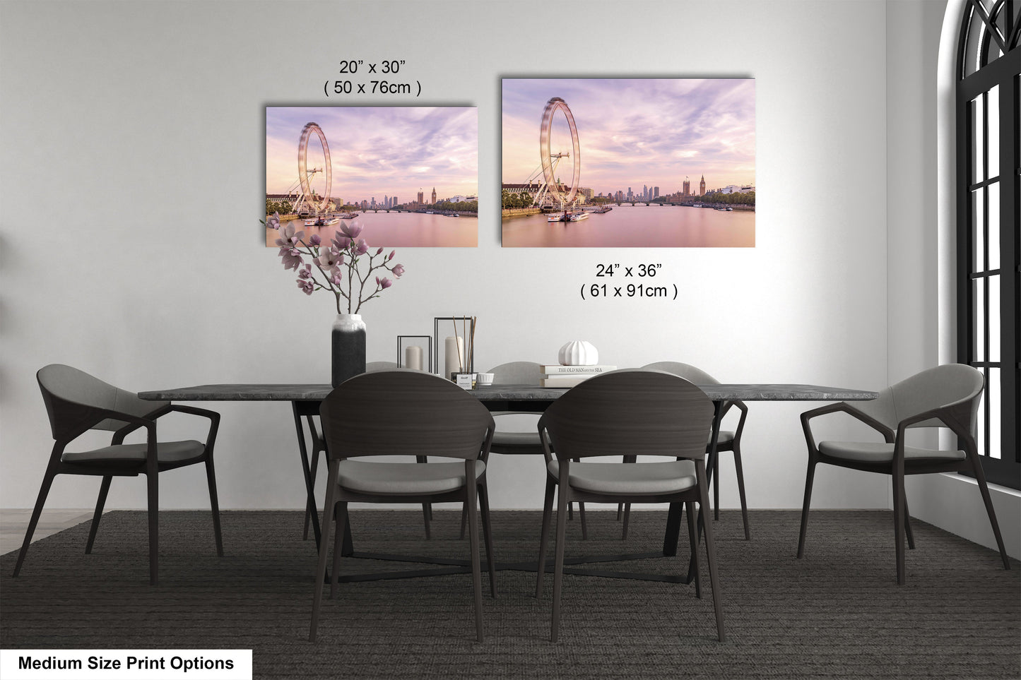 a dining room table with four chairs and a vase of flowers