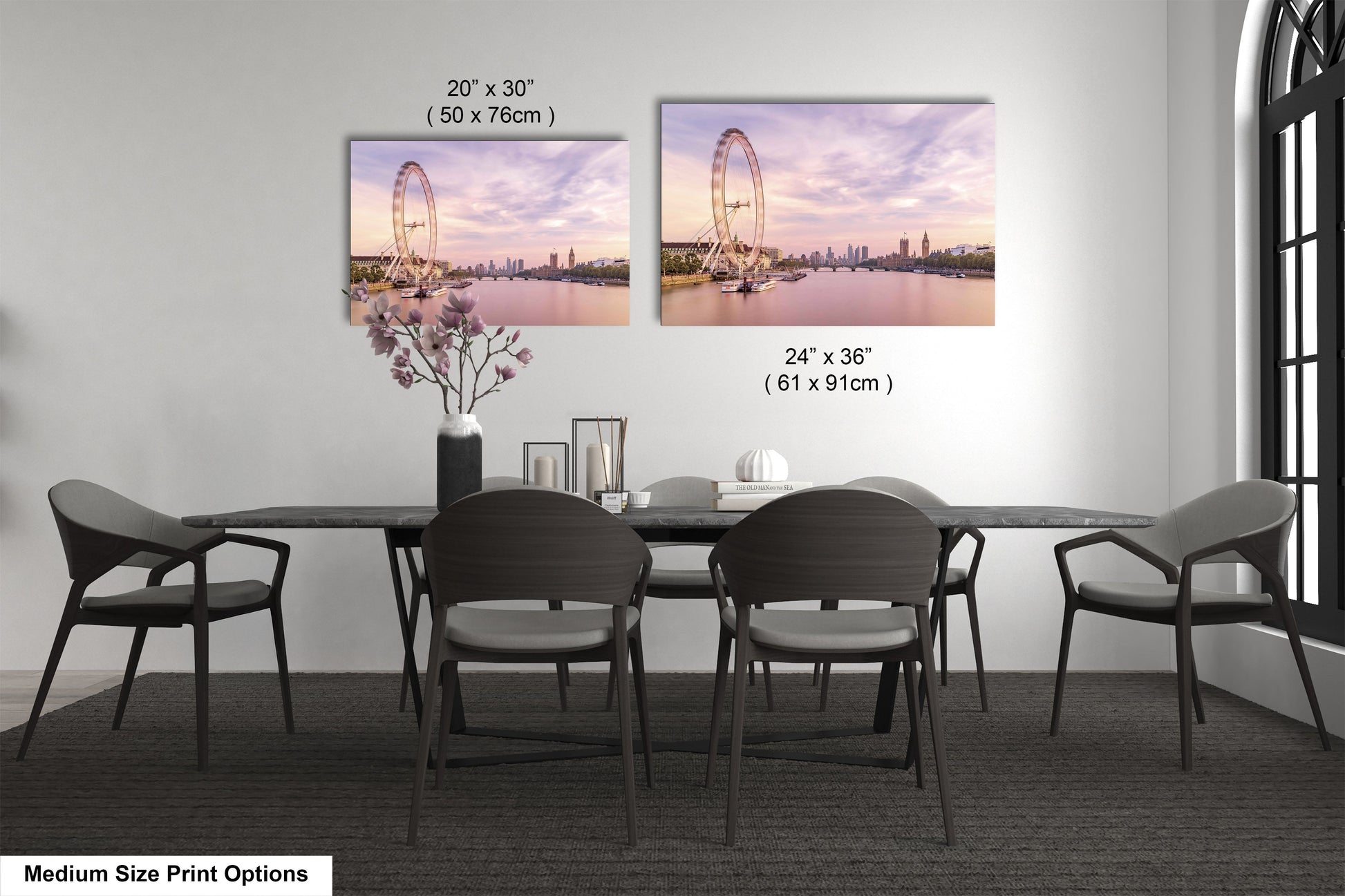 a dining room table with four chairs and a vase of flowers