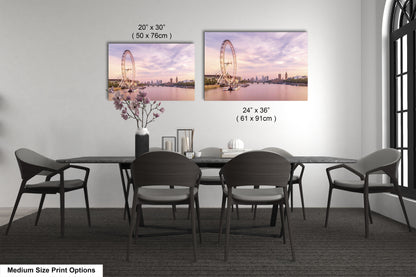 a dining room table with four chairs and a vase of flowers