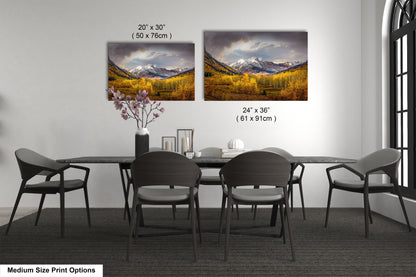 a dining room table with four chairs and a vase with flowers