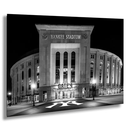 the Yankee Stadium, a large stadium located in New York City, with its iconic curved facade and illuminated signage.