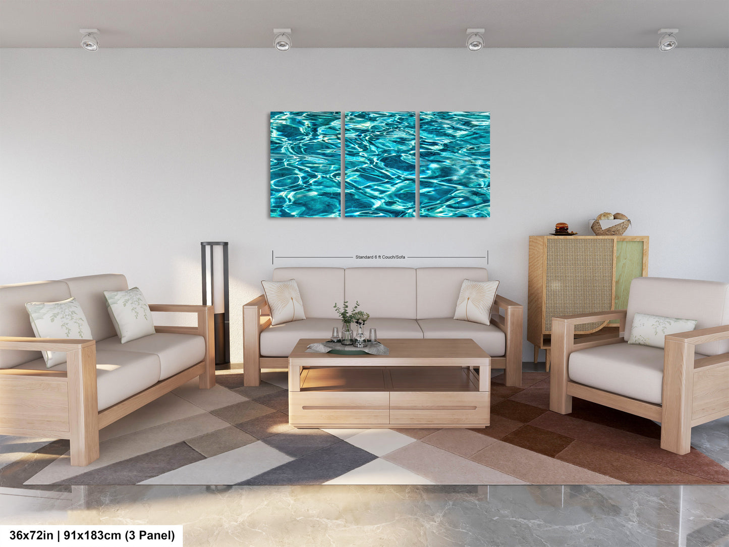 A modern living room with a white sofa, two chairs, and a coffee table. Above the furniture, there is a large wall art piece depicting a blue water surface. The room has a minimalist and clean design, with a geometric patterned rug on the floor.