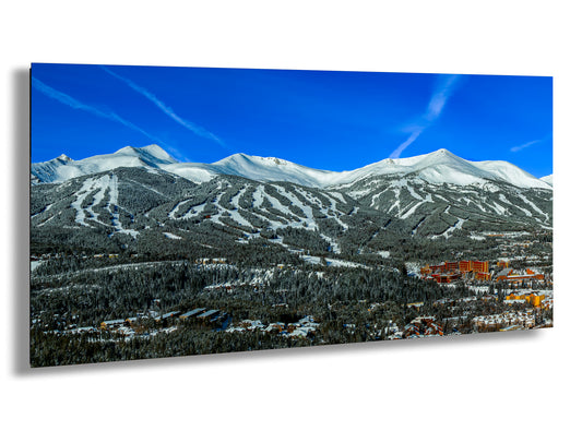a scenic view of a ski resort with mountains in the background