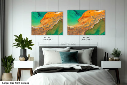 a bed with two paintings on the wall above it