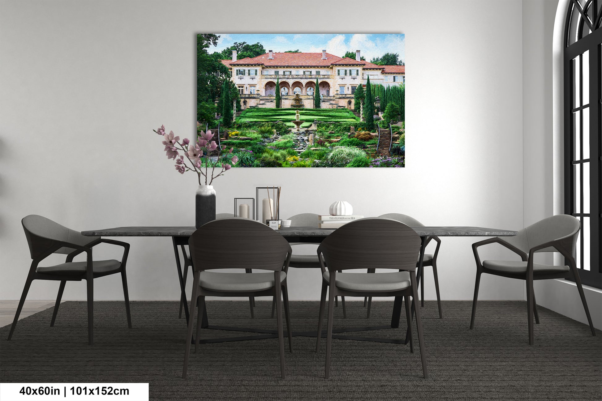 a dining room table with chairs and a painting on the wall