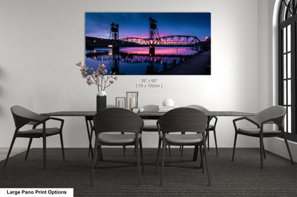 a dining room table with chairs and a painting on the wall