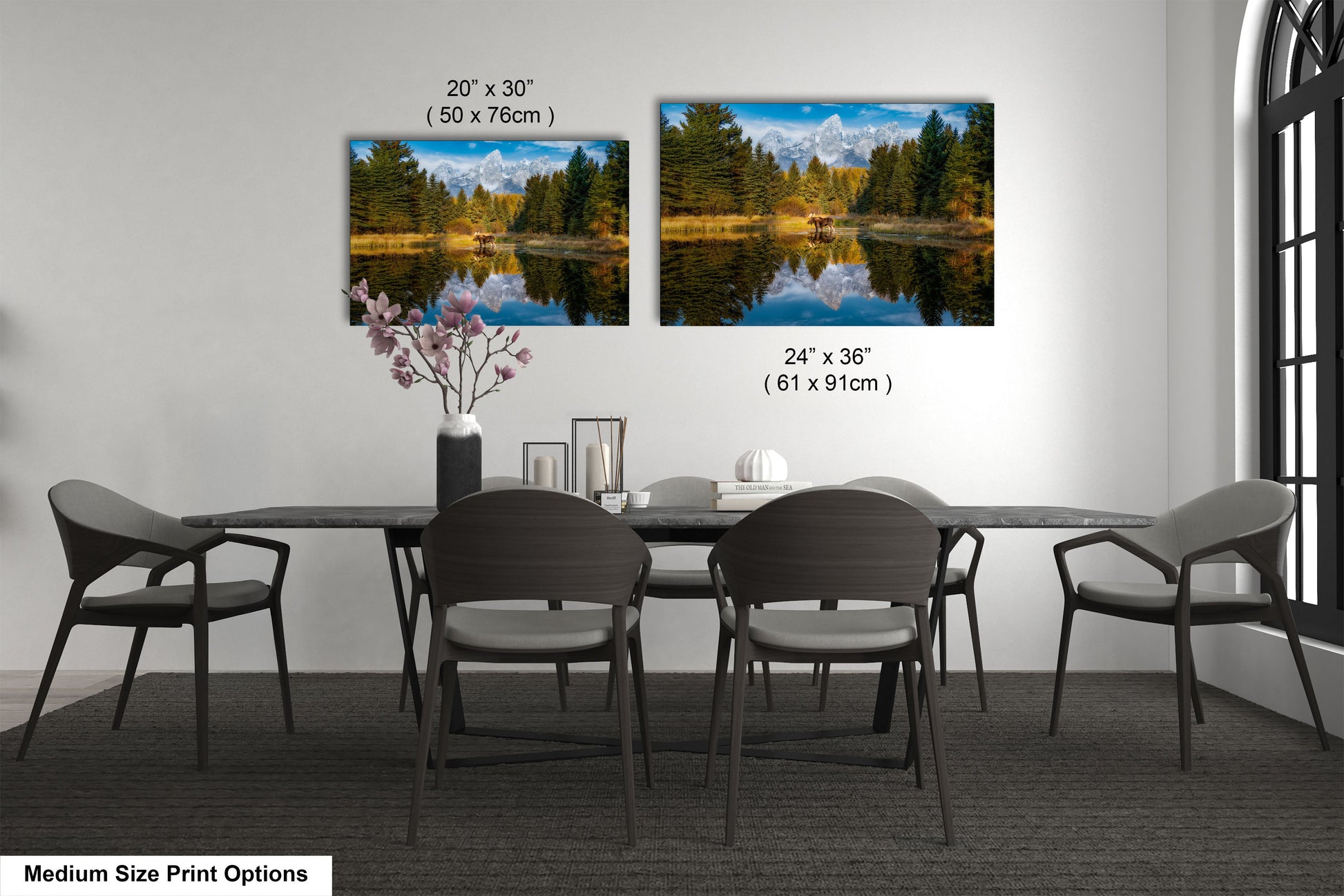 a dining room table with four chairs and a vase with flowers