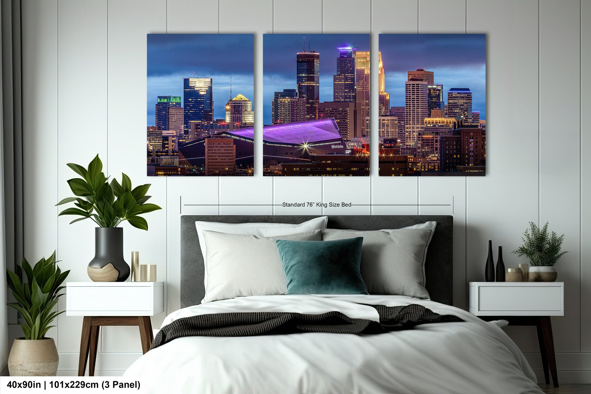 a bedroom with a large bed and two pictures of a city