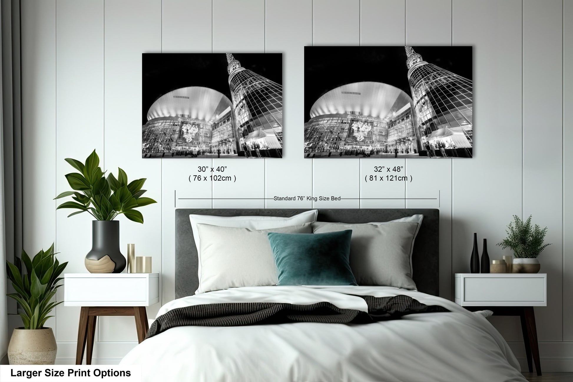 a bed with a white comforter and two black and white pictures on the wall