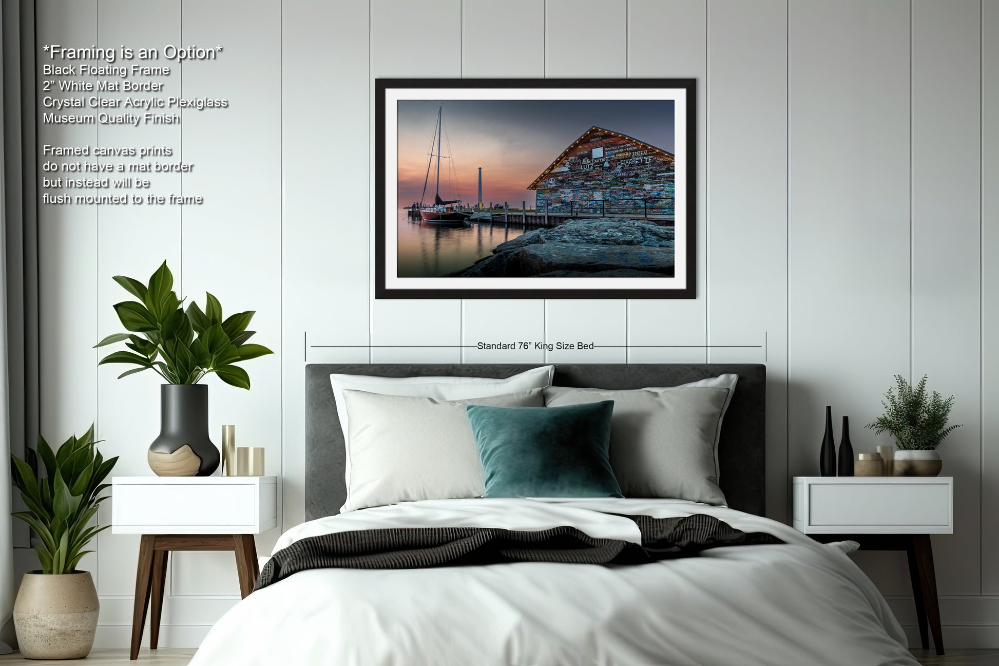 a bedroom with a large bed, a nightstand on each side, and a framed picture of a building with a sailboat docked in the background.