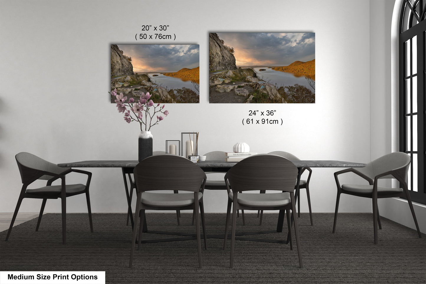 a dining room table with four chairs and a vase of flowers