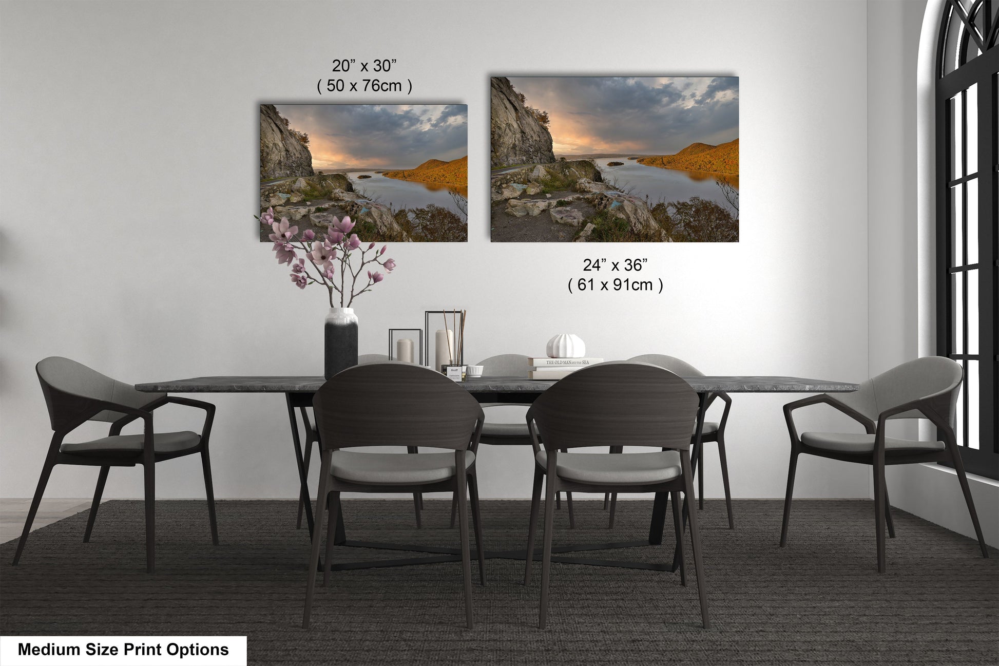 a dining room table with four chairs and a vase of flowers