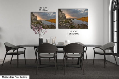 a dining room table with four chairs and a vase of flowers
