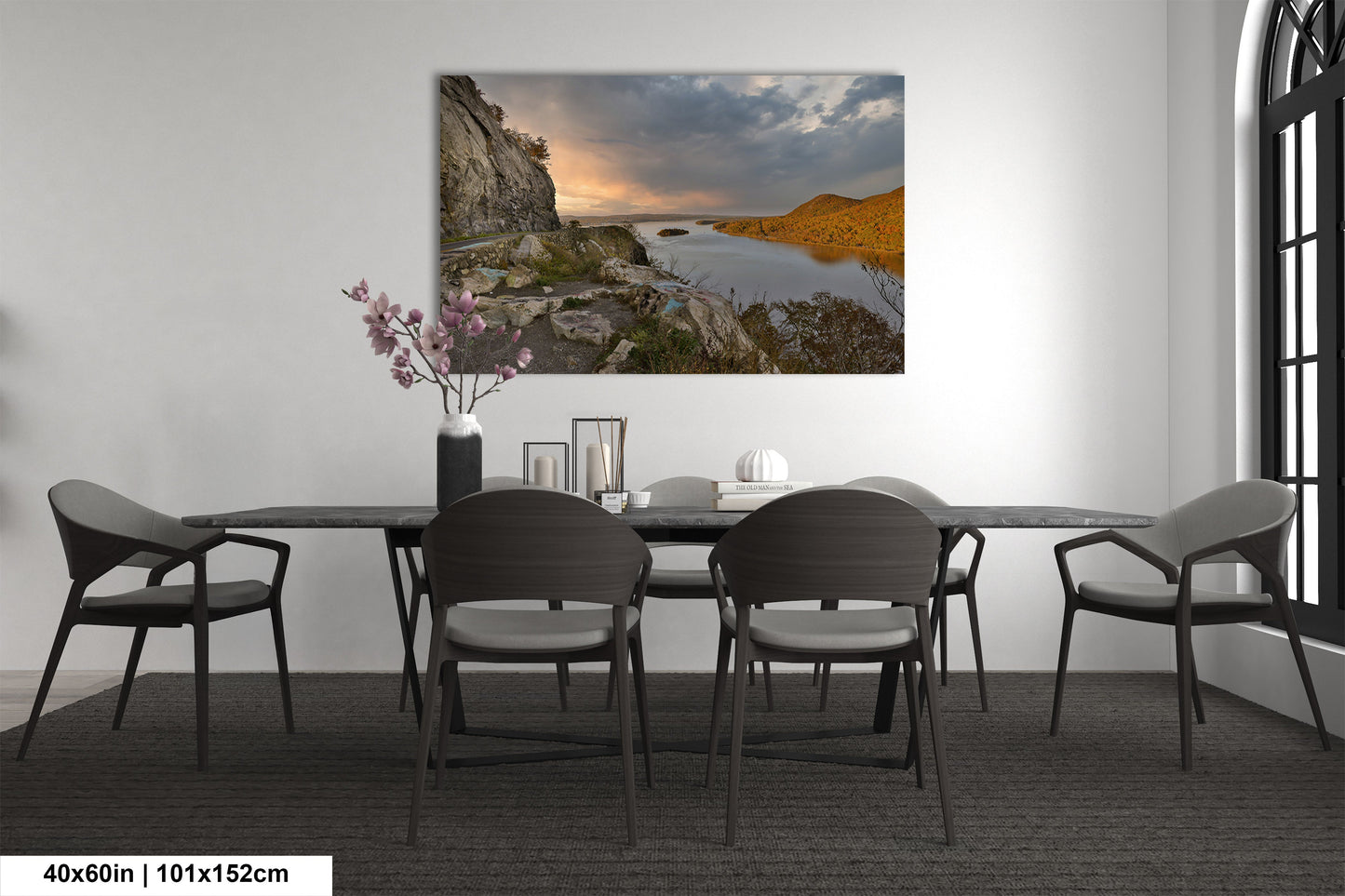 a dining room table with chairs and a painting on the wall