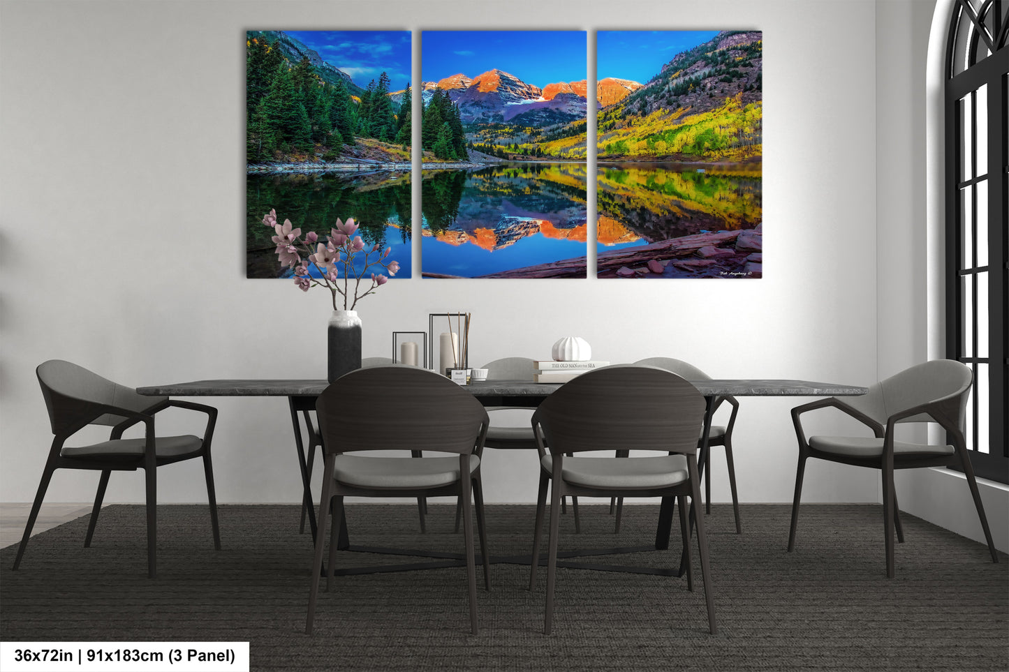 a dining room table with four chairs and a painting on the wall