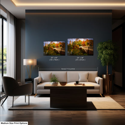 The image is a modern living room with a large window, a white sofa, a coffee table, and a potted plant. There are two framed landscape paintings hanging on the wall, one depicting a bridge and the other showing a scenic view of a forest. The paintings are of medium size, and the dimensions are provided in inches.
