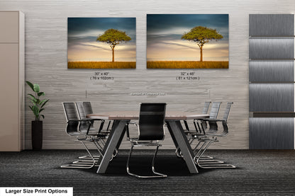 a dining room table with chairs and two pictures of a tree